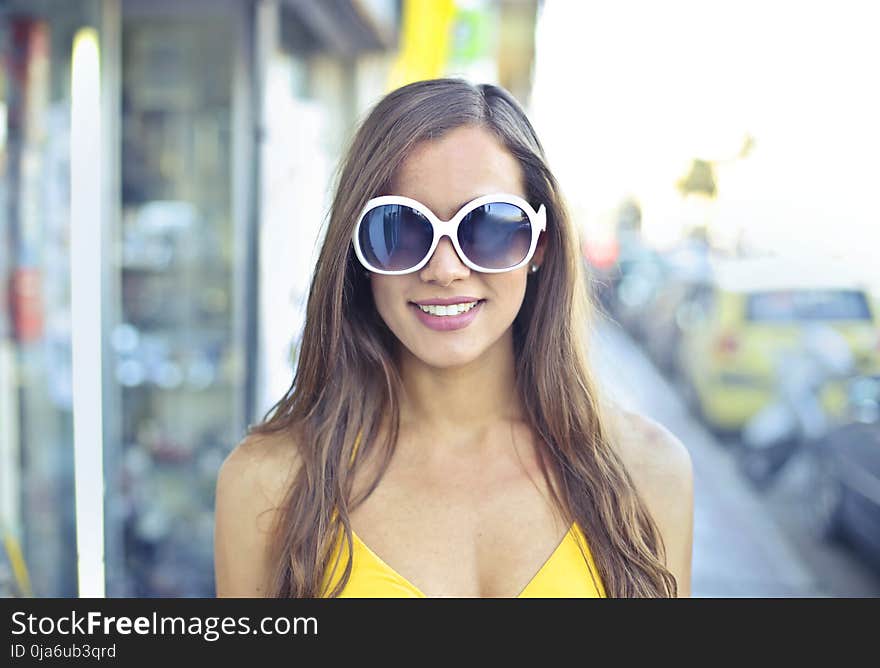 Woman Wearing Yellow Spaghetti Strap Top and Round Sunglasses