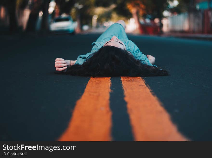 Woman in Blue Dress Lying Down on the Street