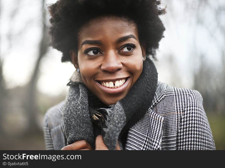 Woman Wearing Black And White Houndstooth Coat And Black Scarf