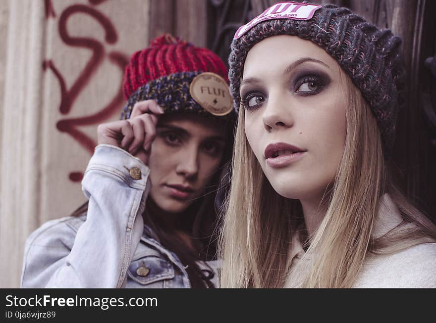 Two Women in Beanie Caps Taking Selfie