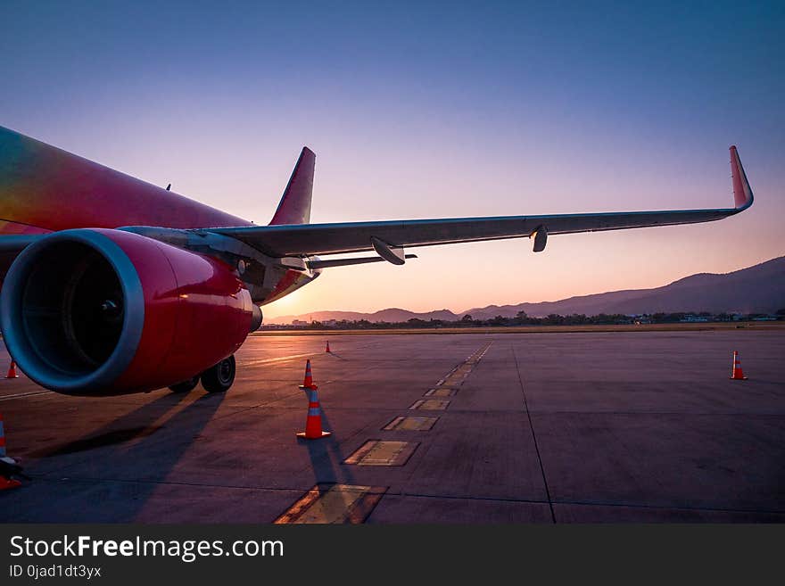 The left wing of the aircraft parking for passengers at the international airport.