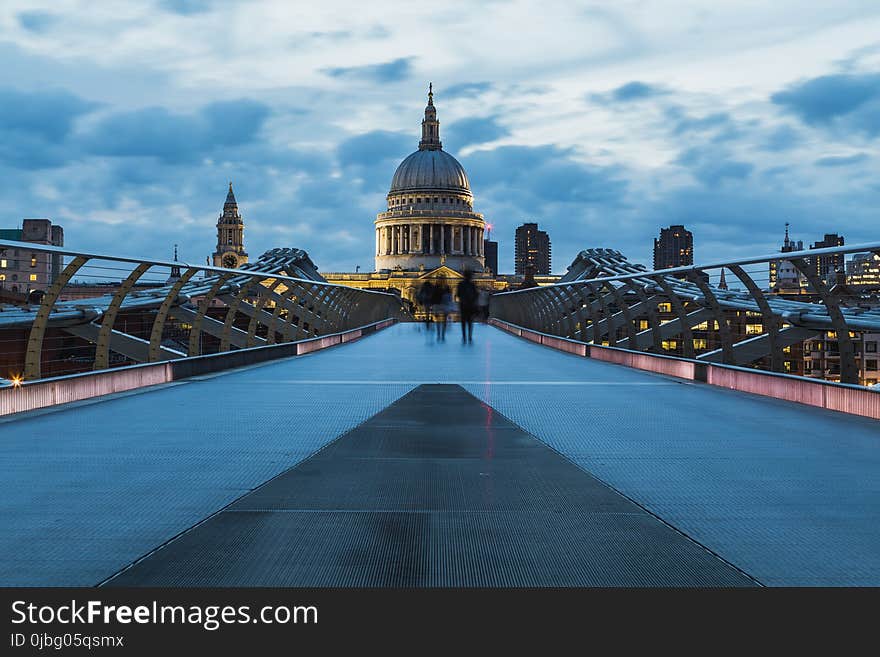 People Walking on Tile Floor With Railings