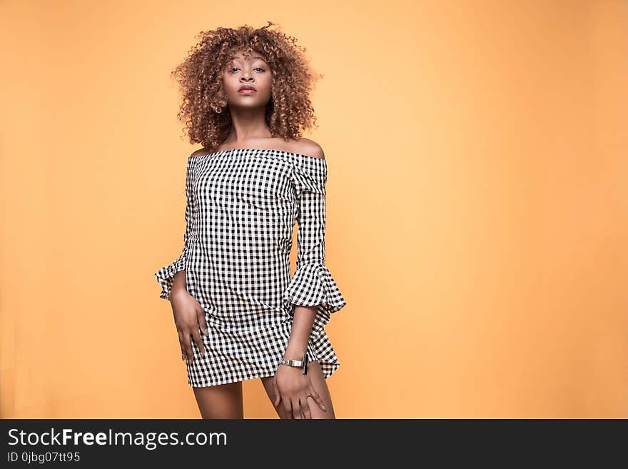 Woman Wearing Checked Bell-sleeved Dress With Orange Background