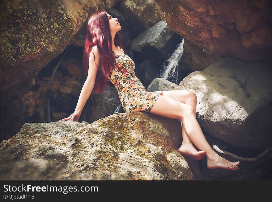 Woman in Bodycon Mini Dress Sitting on Boulder