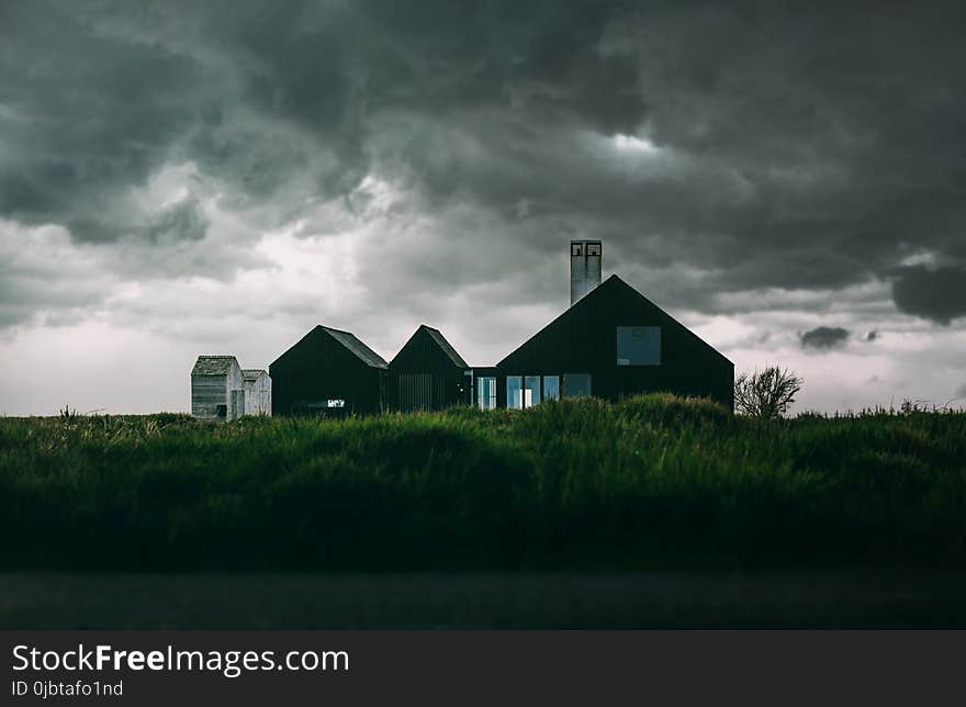 Black and White House Under Thick Clouds