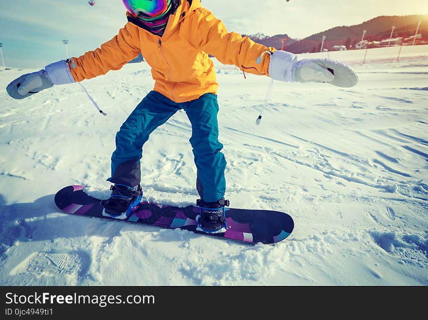 woman snowboarding in winter mountains