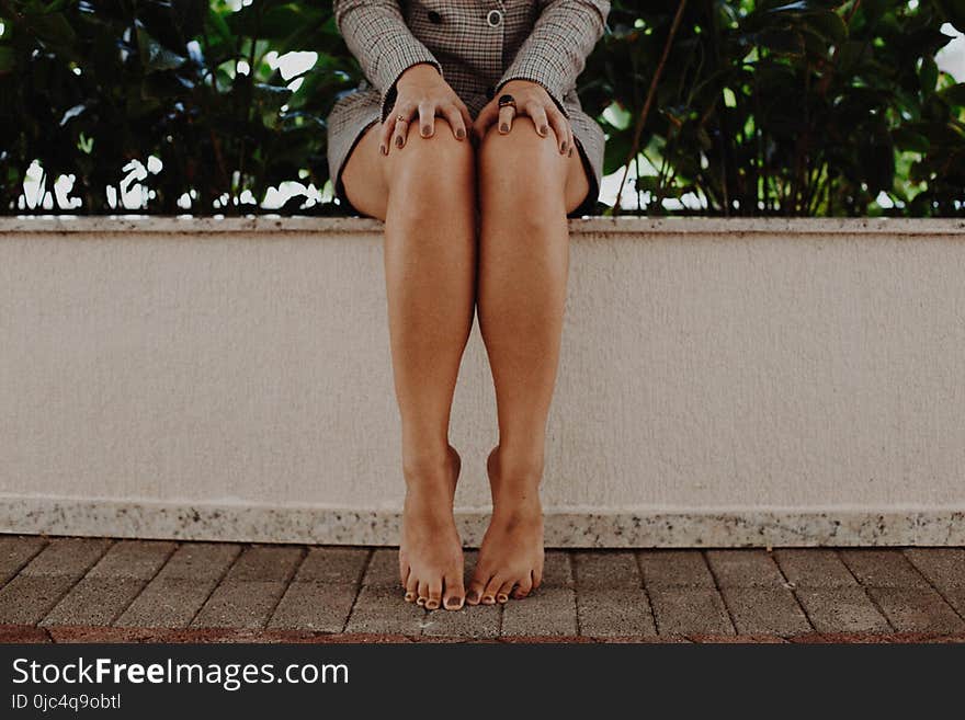 Person Wearing Gray Long-sleeved Mini Dress in Front of Green Leaf Plant