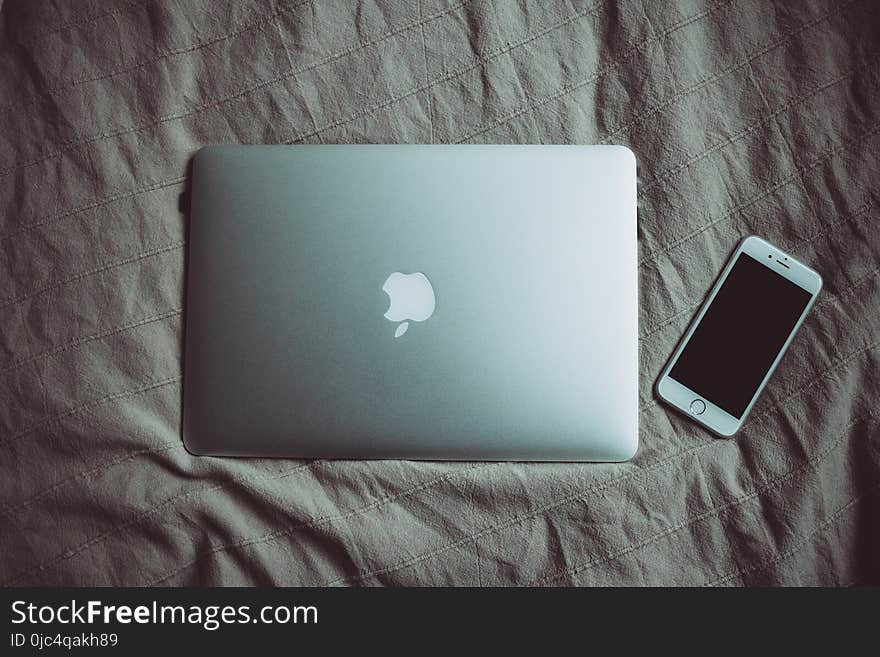 Silver Macbook Beside Silver Iphone 6