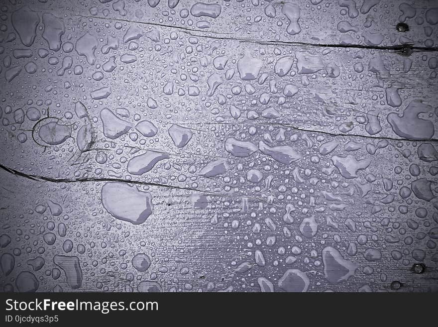 Wooden surface of violet color covered with water drops filtered background. Wooden surface of violet color covered with water drops filtered background.