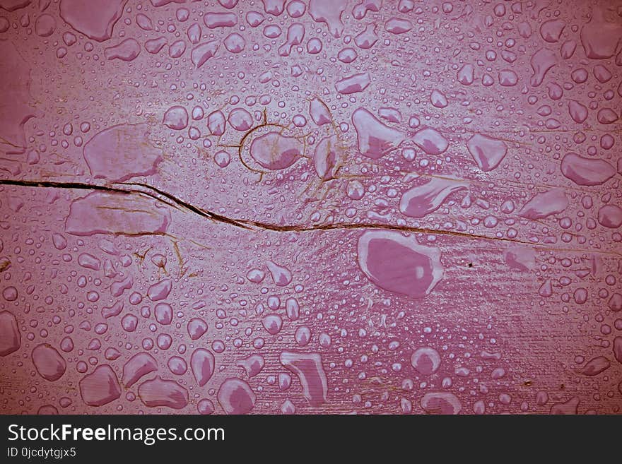 Wooden surface of violet color covered with water drops filtered background. Wooden surface of violet color covered with water drops filtered background.