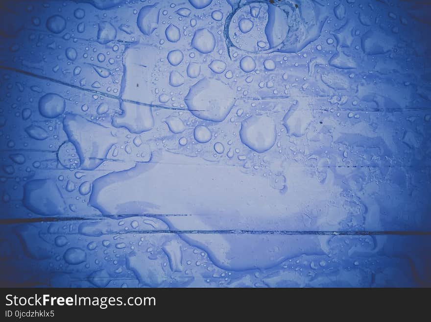 Wooden surface of violet color covered with water drops filtered background. Wooden surface of violet color covered with water drops filtered background.