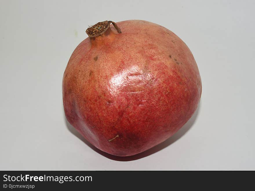 Pomegranate white fruit background red ripe food tropical fresh vegetarian sweet juicy. Pomegranate white fruit background red ripe food tropical fresh vegetarian sweet juicy