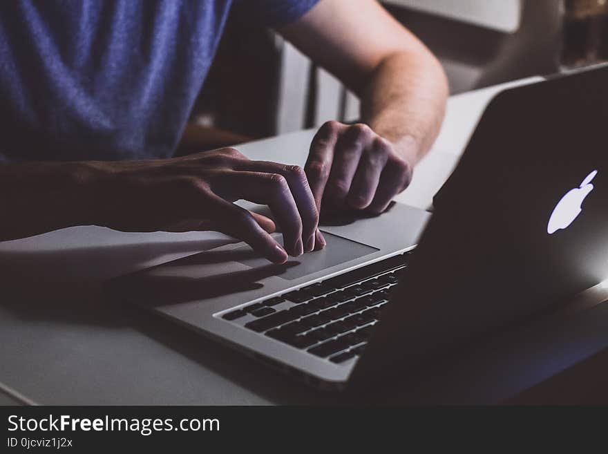 Person Touching Open Macbook on Table