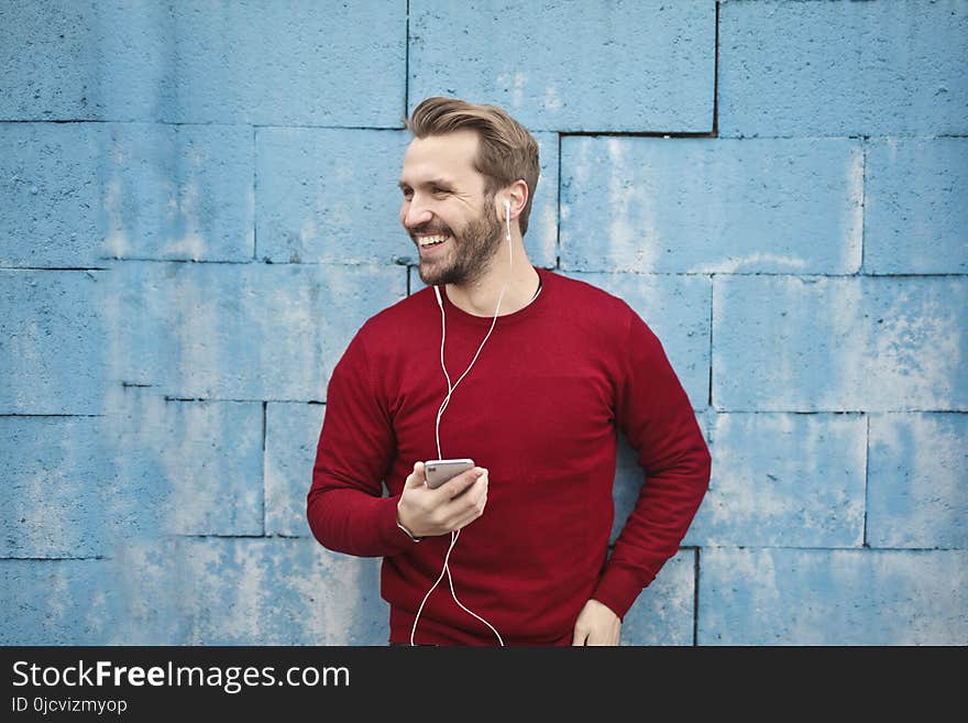 Photo of a Man Listening Music on his Phone