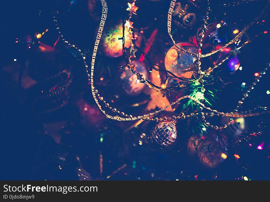 Decorated Christmas tree and colorful garland lights, filtered. Decorated Christmas tree and colorful garland lights, filtered.