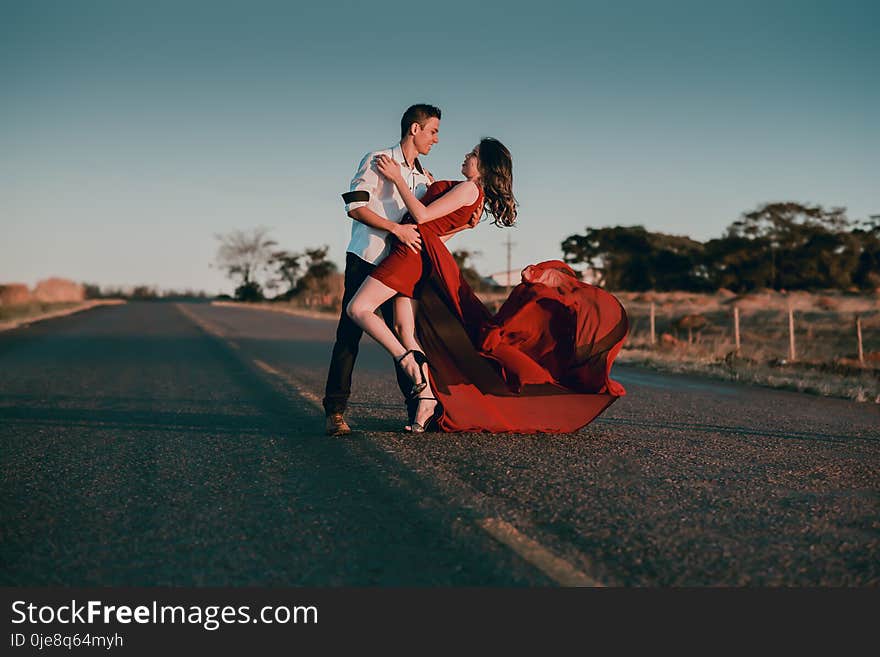 Man and Woman Doing Dance Post in Concrete Road at Daytime