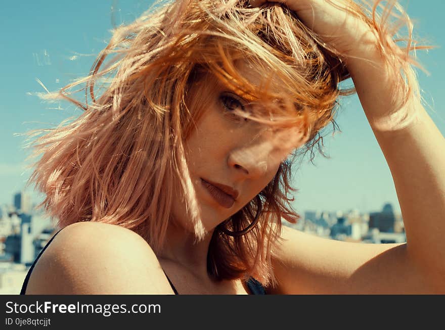 Close-up Photography of a Woman Touching Her Hair