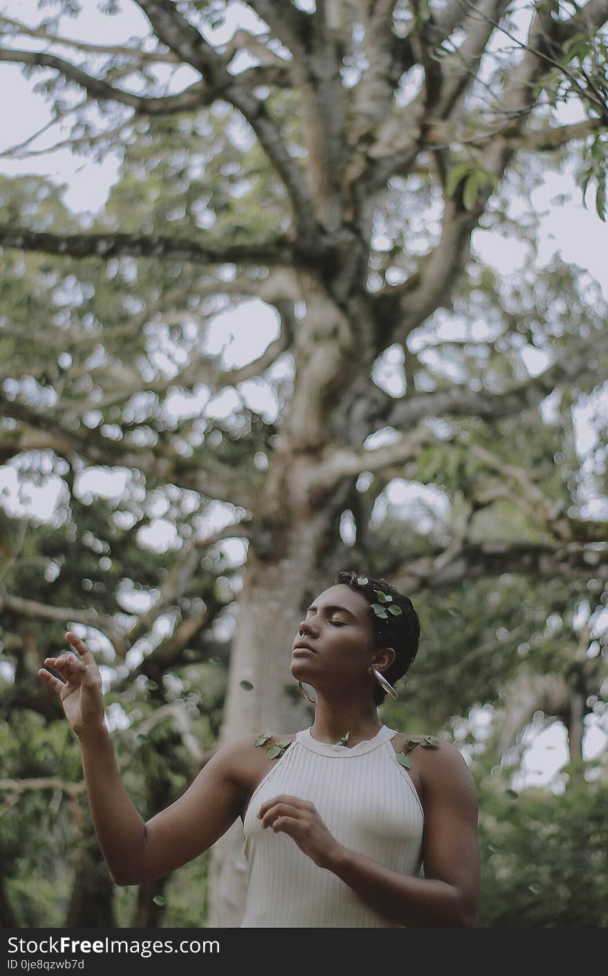 Woman Closing Her Eyes With Leaves on Her Shoulder