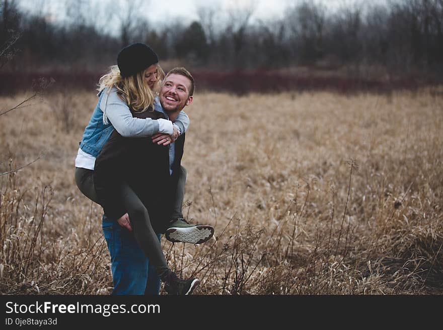 Photo of a Man Carrying His Partner