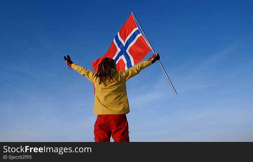 Man with norway flag on the top point. Succesful winer consept.