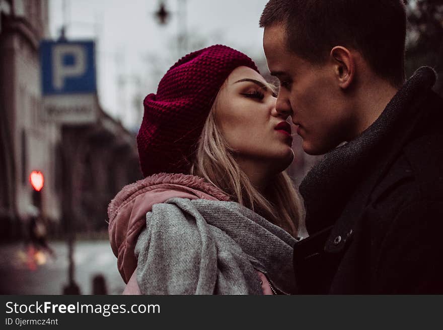 Close Up Photograph of Woman Kissing Man