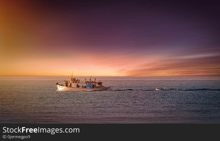 Boat Sailing on Body of Water