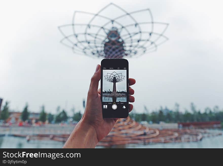 Person Taking Photo of Tower