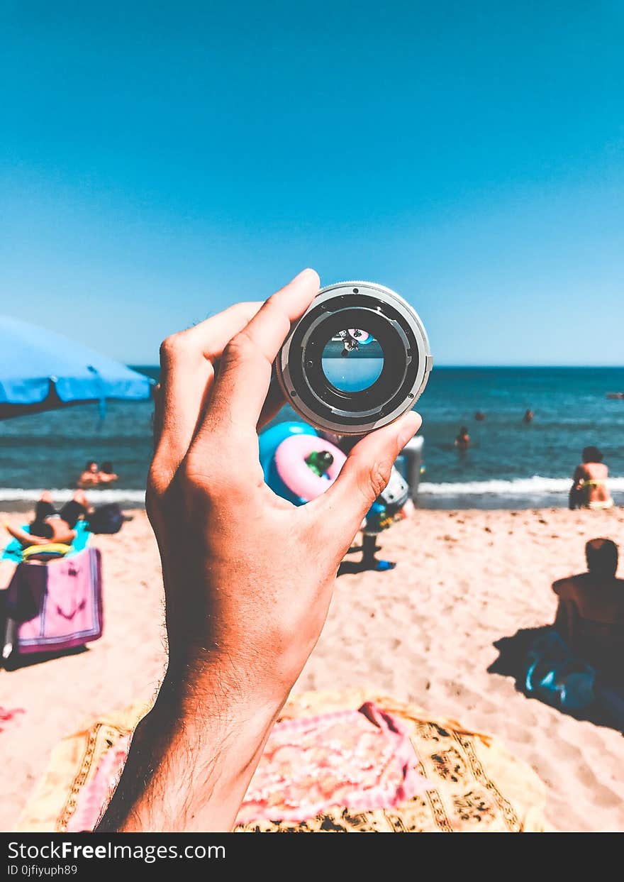 Person Holding Camera Lens