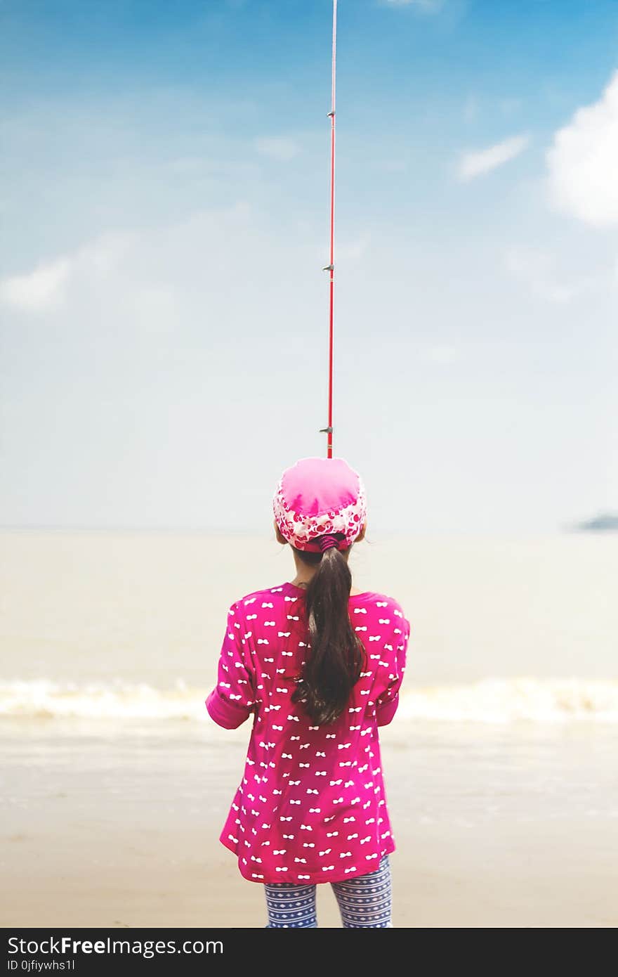 Woman in Pink Long-sleeved Shirt Holding Red Fishing Rod