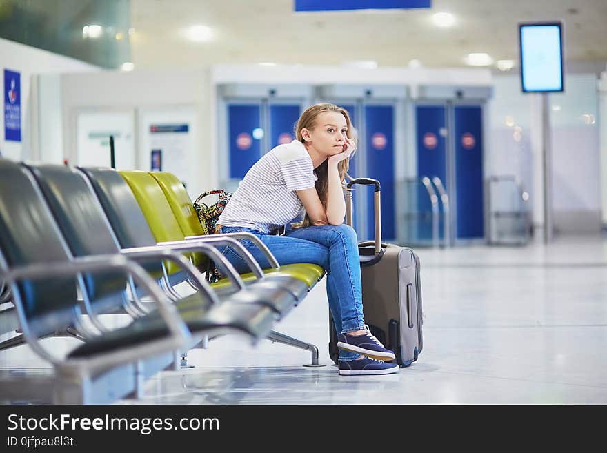 Young woman in international airport waiting for her flight