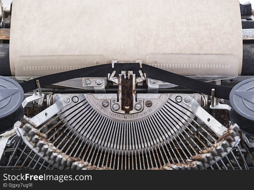 Blank sheet of paper inserted into the vintage typewriter for typing. Blank sheet of paper inserted into the vintage typewriter for typing