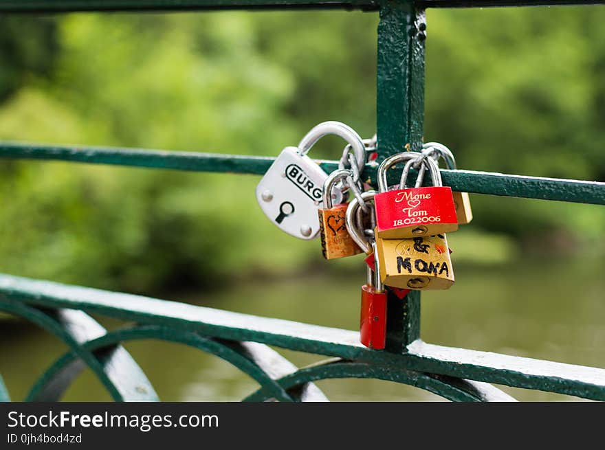 Silver Brown and Red Padlock on Green Steel Trail