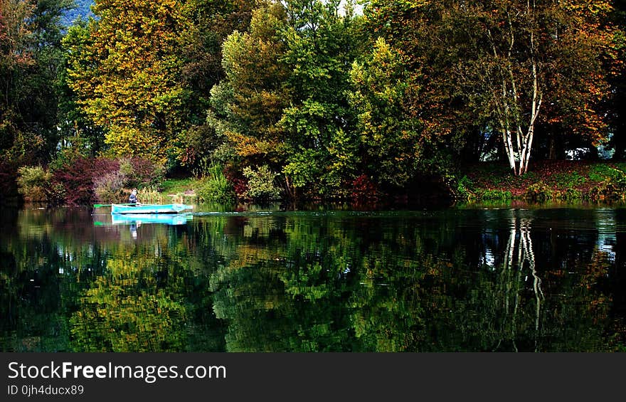 Blue Boat on Sail on Calm Body of Water during Daytime