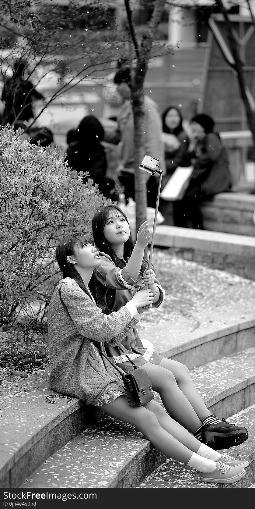 Grayscale Photography of 2 Women Sitting on Floor