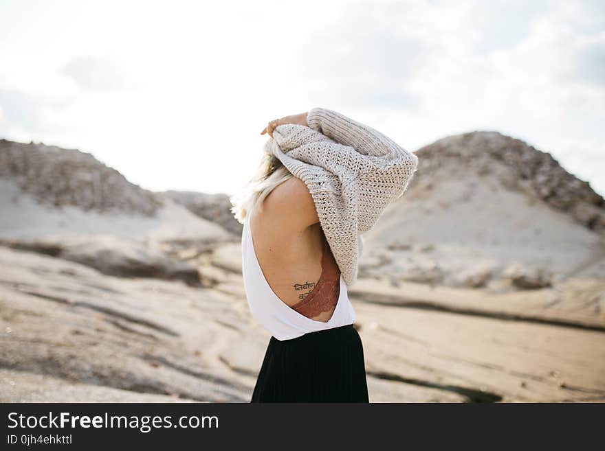 Women Taking Off knitted sweater