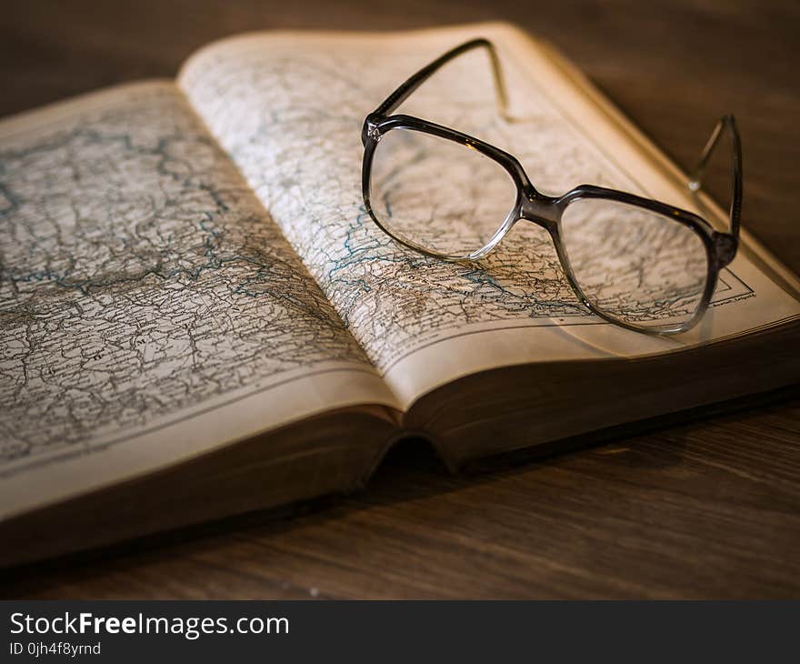 Black Framed Eyeglasses on Book