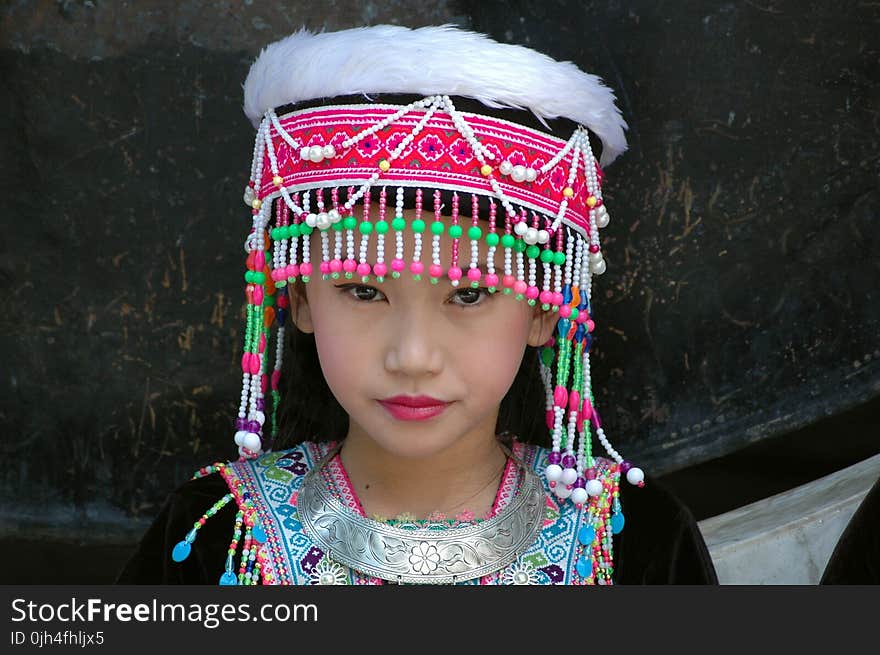 Girl Wearing Pink and Green Beaded Cap