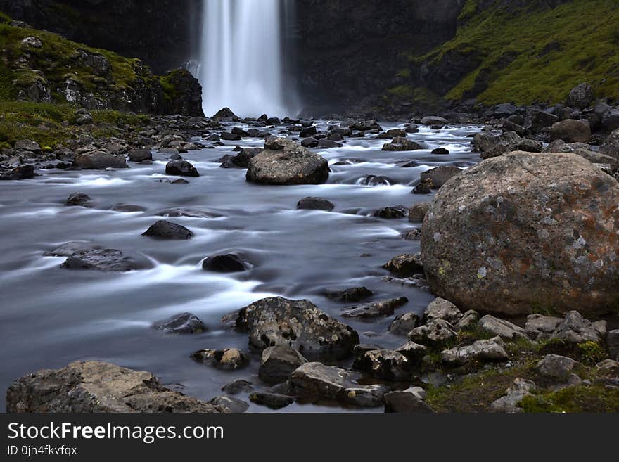 Brown Rock Besides Body of Water