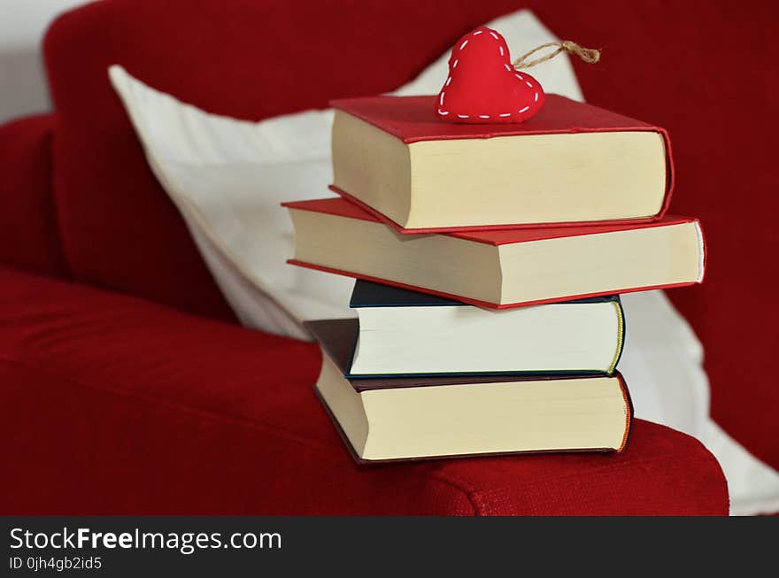 Red Heart Keychain on Top of Stacking of Books