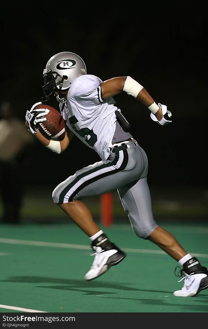 Football Player Holding Football