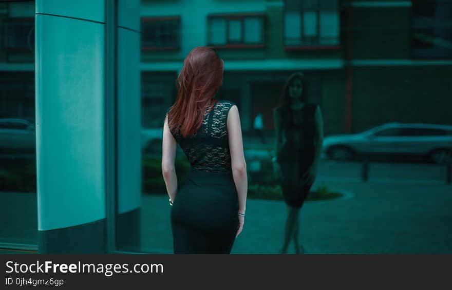 Woman in Black Lace Bodycon Dress in Front of Building Mirror