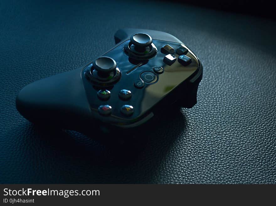 Black Wireless Game Controller on Black Leather