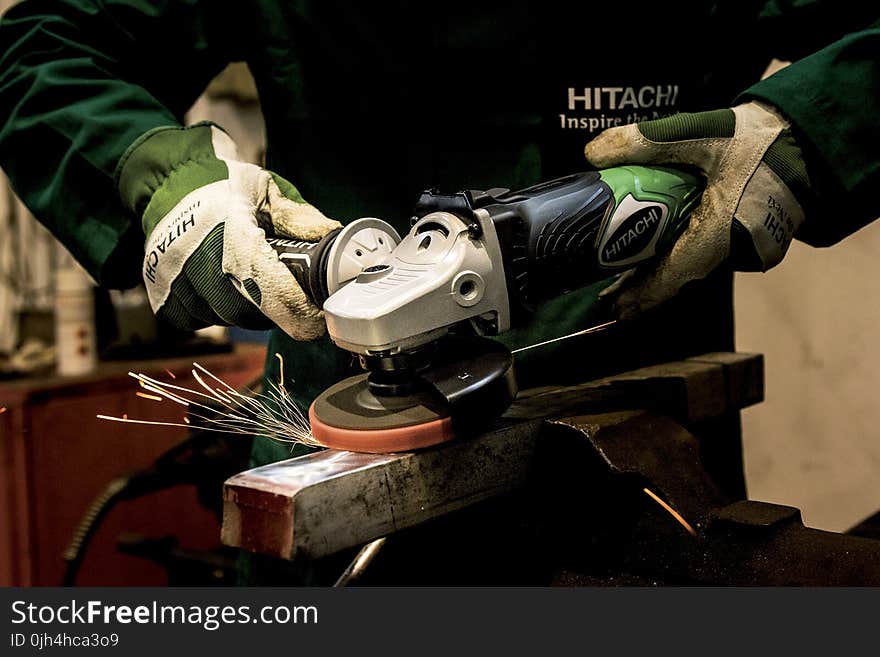 Person Holding Gray and Black Angle Grinder