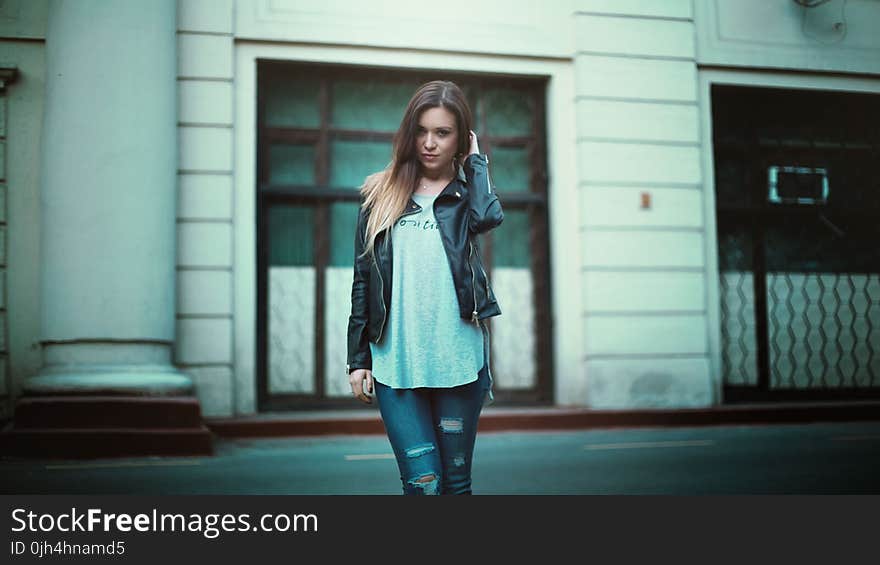 Woman in Gray Printed Shirt With Black Leather Jacket and Black Distressed Jeans