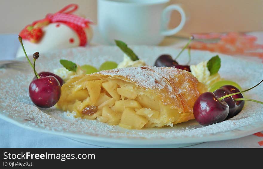 Yellow Pastry and Red Cherry in White Ceramic Dining Plate