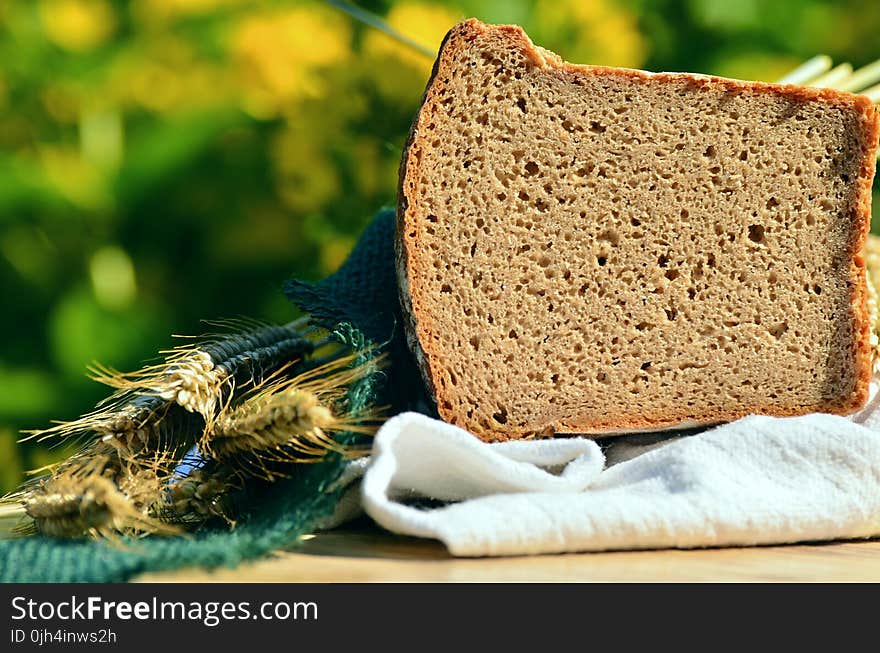 Loaf Bread on Top of White Textile