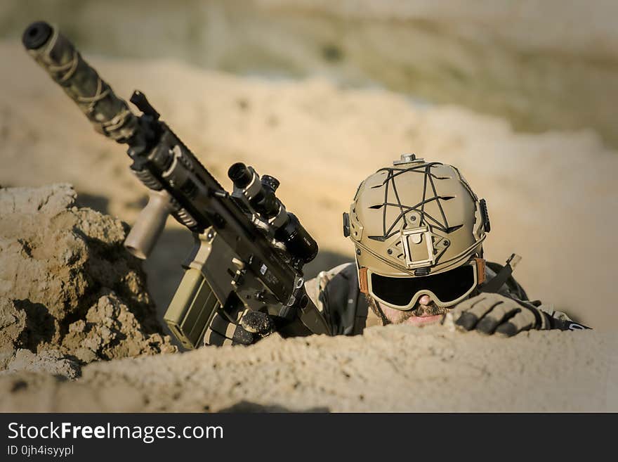 Soldier Wearing Brown Helmet Holding Assault Rifle during Daytime