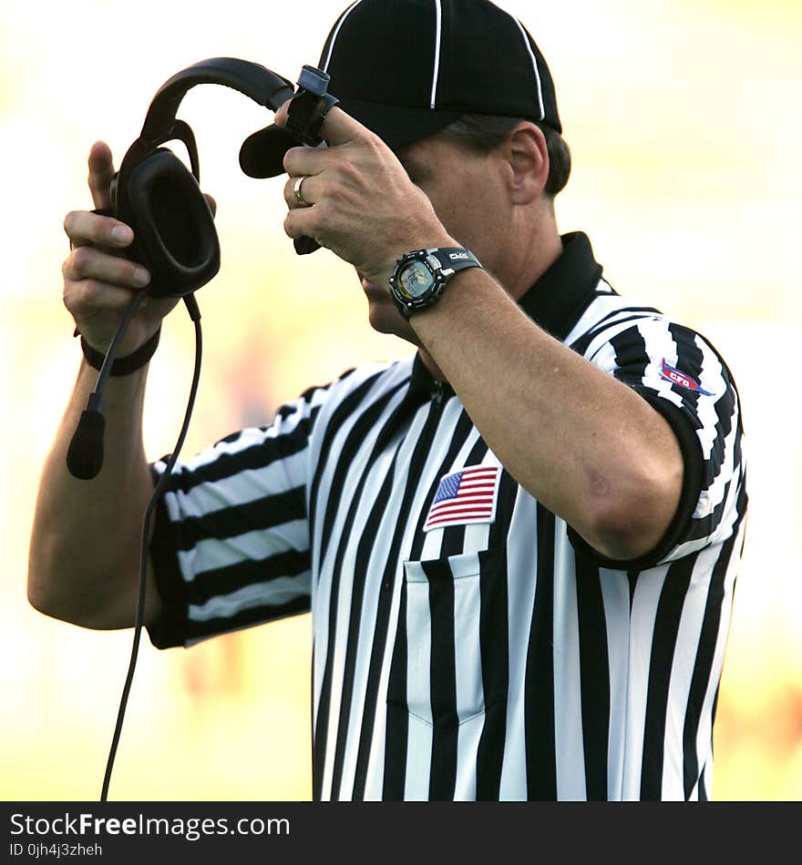 Man in Black Fitted Cap Holding Black Corded Headset