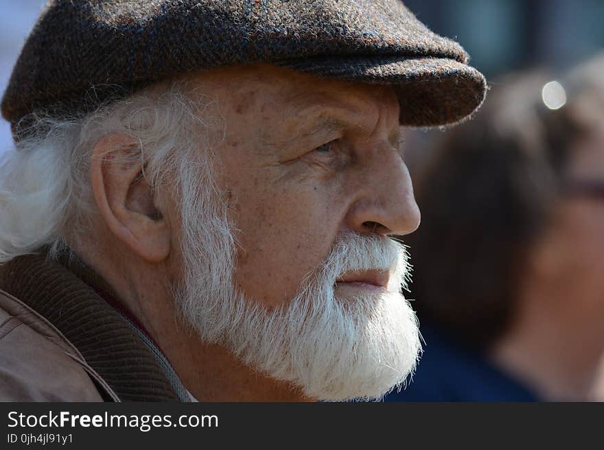 Selective Focus Photography of Man in Flat Cap during Daytime