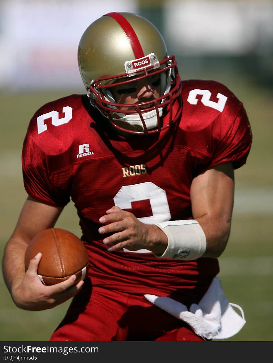 Man in Red Football Field during Daytime